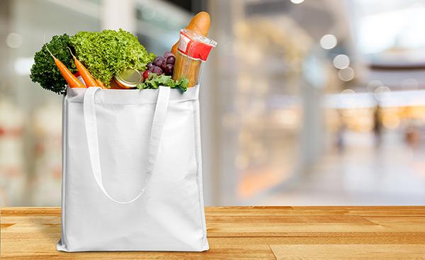 fresh groceries placed in a white bag